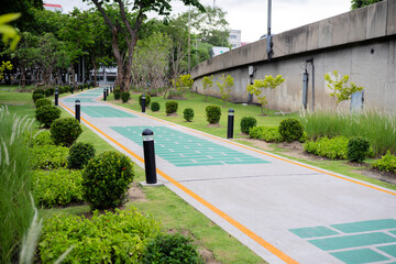 Running track with shade under the trees in public park in summer