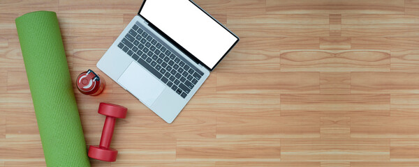 top view Laptop with yoga mat on the wood floor. Panorama concept