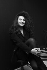 Emotional portraits of a beautiful and curly girl in a jacket