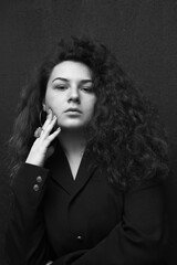 Emotional portraits of a beautiful and curly girl in a jacket
