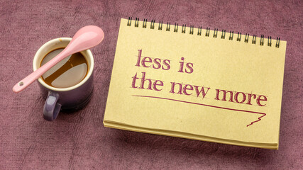 less is the new more - minimalism concept, handwriting in a spiral notebook with a cup of coffee