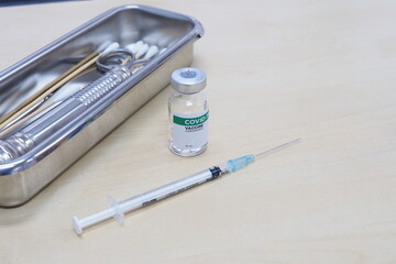 COVID-19 vaccine and syringes on table with copy space. Healthcare And Medical concept.