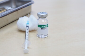 COVID-19 vaccine and syringes on table with copy space. Healthcare And Medical concept.