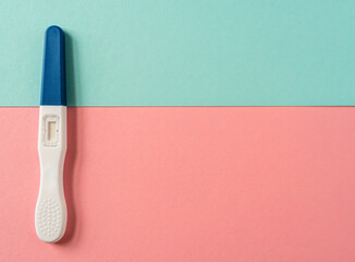 Pregnancy test on blue and pink background