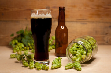 Glass of dark beer with hops