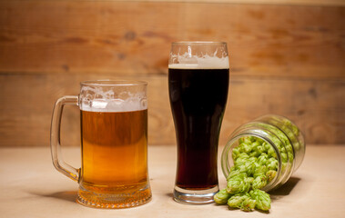 Glass of dark and light beer with hops