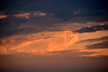 Evening cumulus red and blue clouds over the city