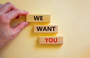 We want you symbol. Wooden blocks with words 'We want you' on beautiful white background. Businessman hand. Business, hiring and we want you concept.