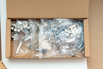 cardboard box with fittings in packets for furniture assembly at home