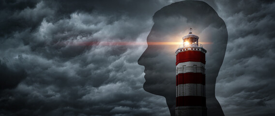 The lighthouse points the way against the background of a silhouette of a man Concept on the topic of psychology, psychiatry, self-development. Lighthouse symbolises the search for oneself.