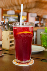 Summer fresh non-alcoholic cocktail berry juice in a transparent glass