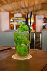 Summer fresh non-alcoholic mojito cocktail with mint, ice and lime in a transparent glass