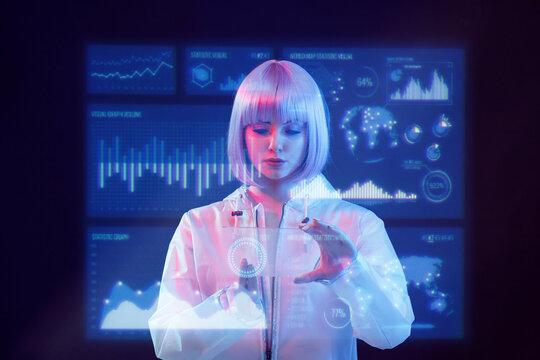 Woman with futuristic tablet in hand. Girl in glasses of virtual reality presses the start button. Augmented reality game, future technology, AI concept. Holographic interface to display data.