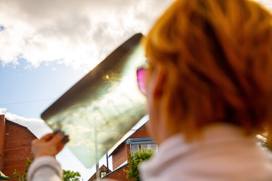 Woman Watching Solar Eclipse Through X-ray Images In Sunny Day