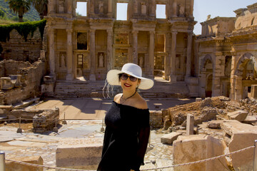 happy woman in a hat in ephesus ancient city, izmir