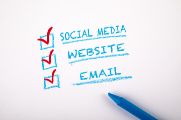 Fototapeta premium Digital Marketing concept. Social Media, Website and Email. Checklist on a sheet of white paper