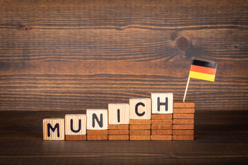 MUNICH city in germany. Wooden alphabet letters and German flag on a wooden background