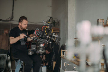 Director of photography with a camera in his hands on the set. Professional videographer at work on filming a movie