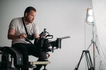 Director of photography with a camera in his hands on the set. Professional videographer at work on filming a movie