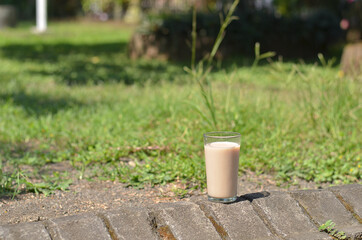 Iced milk tea in the glass refreshing look with blurred background. selective focus