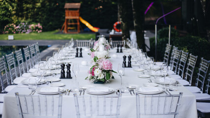 tableware Glasses, flower fork, knife served for dinner in restaurant with cozy interior