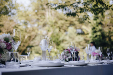 tableware Glasses, flower fork, knife served for dinner in restaurant with cozy interior