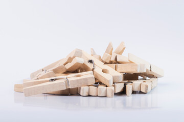 Wooden clothespins for drying clothes. Clothespins on an isolated white background. 
