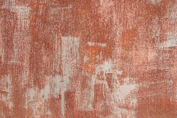 Fragment of a steel sheet covered with red-brown paint. There are irregular gray strokes. Rust points appear everywhere. Background. Texture.