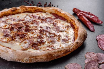 Foto op Plexiglas Fresh delicious Italian pizza with four types of meat on a dark concrete background © chernikovatv
