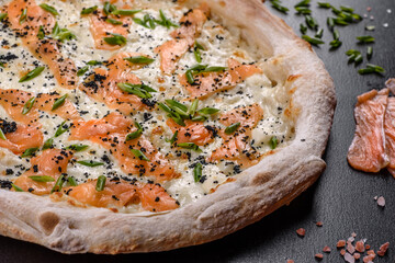 Tasty sliced pizza with seafood and tomato on black background
