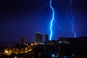 Thunderstorm over the city in blue light. Lightning in the night city, Russia, Yekaterinburg.
