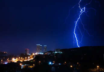 Thunderstorm over the city in blue light. Lightning in the night city, Russia, Yekaterinburg.
