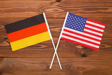 Flag of Germany and flag of USA crossed with each other. The image illustrates the relationship between countries. Photography for video news on TV and articles on the Internet and media. - Powered by Adobe