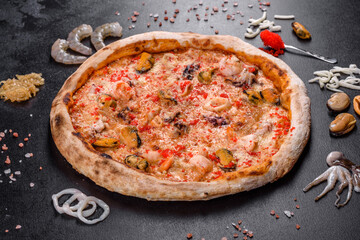 Tasty sliced pizza with seafood and tomato on black background