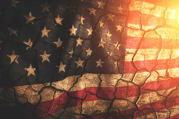 Background is an aged cracked flag United States of America illuminated by sun.