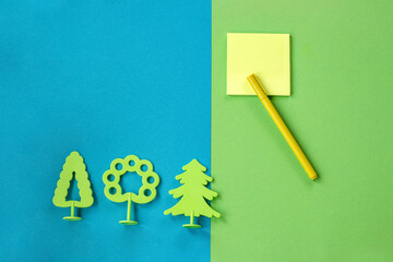 Minimum set of school and office supplies on bright turquoise and green background: pen, note paper...