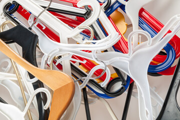 clothes hangers stacked on top of each other, a lot of abandoned hangers, background, sale concept, shop