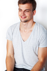Obraz premium young handsome teenage hipster guy posing emotional, happy smiling against white background isolated, lifestyle people concept