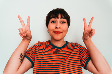 Happy woman looking the camera with peace sign