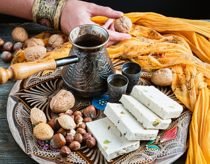 Greek halva, nuts and greek coffee on a colorful tray.