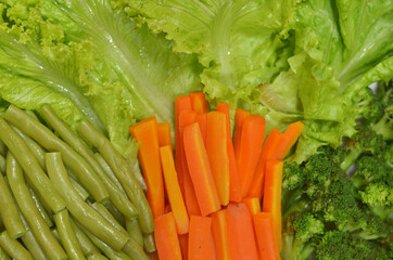 lots of brocolli, carrots, lettuce, and green bean vegetable background