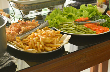 Western Food Dish Background with garlic bread, donuts, vegetables, french fries, slices fried chicken and slices beef steak