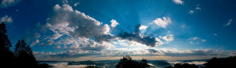 bright sunrise in the mountains with blue sky