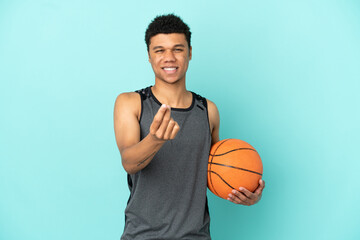 Basketball player African American man isolated on blue background making money gesture