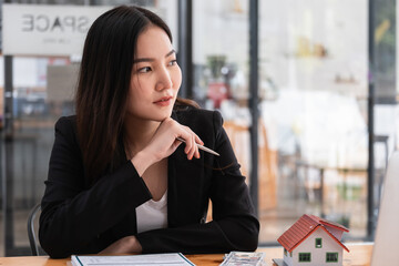 A stressed woman signs a contract to cancel her rent apartment and pay an outstanding payment