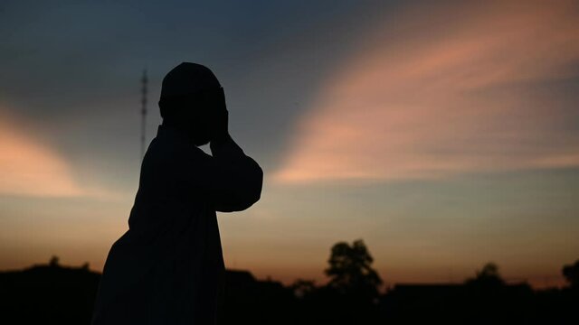 Silhouette Asian islam man prayer,Young Muslim praying,Ramadan festival concept