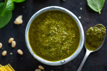 Pesto sauce in small bowl on table