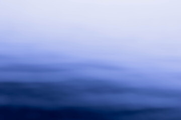 Abstract shot of blurred sea water surface with skyline. Background