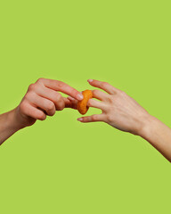 a man's hand puts a cheese ring on a woman's hand.