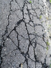 Cracked broken road pavement in the university